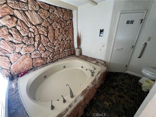 bathroom featuring a washtub and toilet