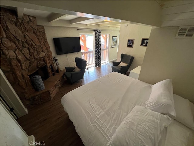 bedroom featuring wood-type flooring and beamed ceiling