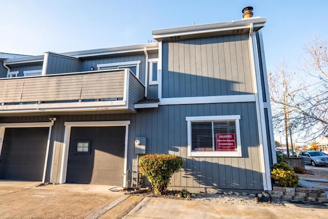 view of front of home with a balcony and a garage