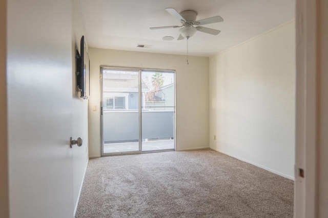 unfurnished room featuring ceiling fan and carpet flooring