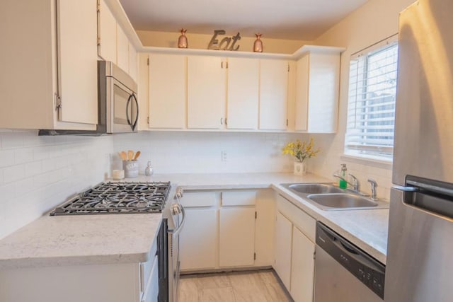 kitchen featuring tasteful backsplash, appliances with stainless steel finishes, and sink