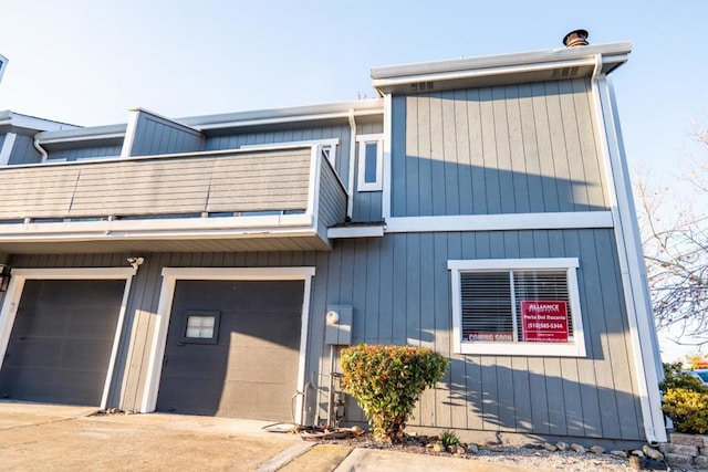 view of front of property with a garage and a balcony