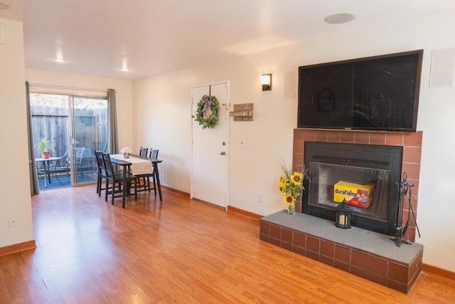 living room featuring wood-type flooring and a fireplace