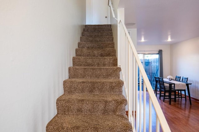 stairs featuring wood-type flooring