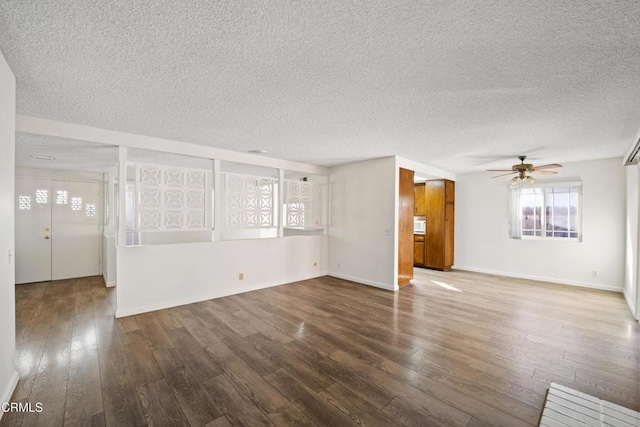 unfurnished living room featuring ceiling fan, a textured ceiling, and hardwood / wood-style floors