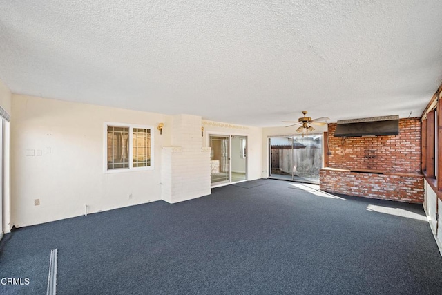 interior space featuring a textured ceiling, ceiling fan, and carpet