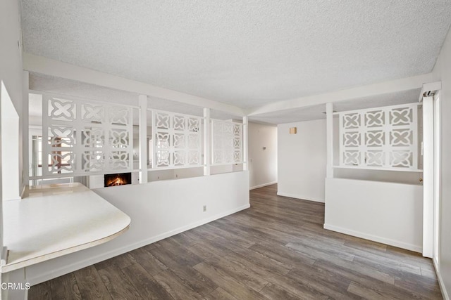 interior space featuring wood-type flooring and a textured ceiling