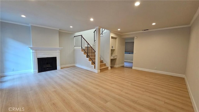 unfurnished living room featuring light hardwood / wood-style flooring and ornamental molding