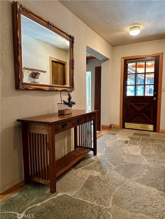 foyer with a textured ceiling