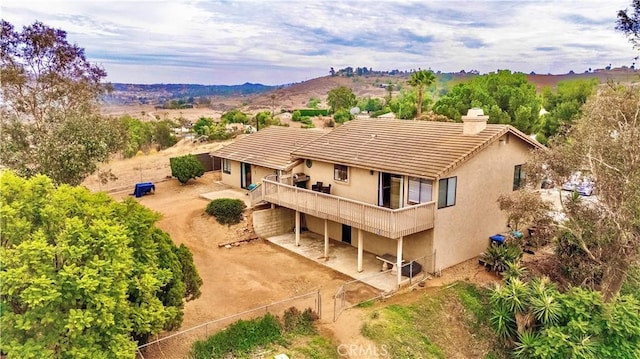 back of property featuring a balcony