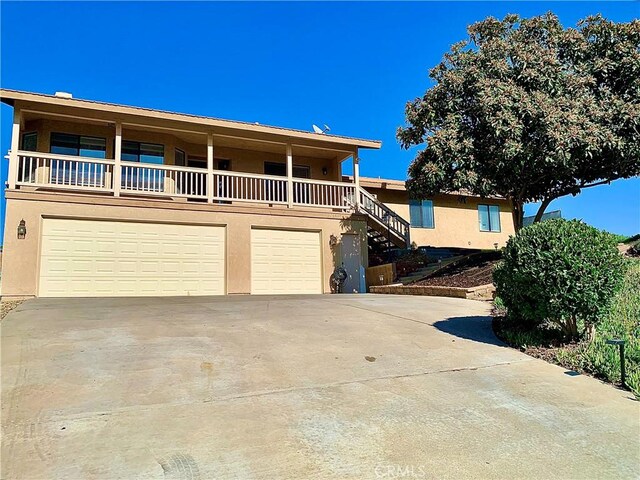 view of front of home featuring a garage and a balcony