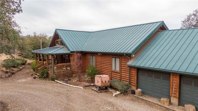 view of home's exterior featuring covered porch and a garage