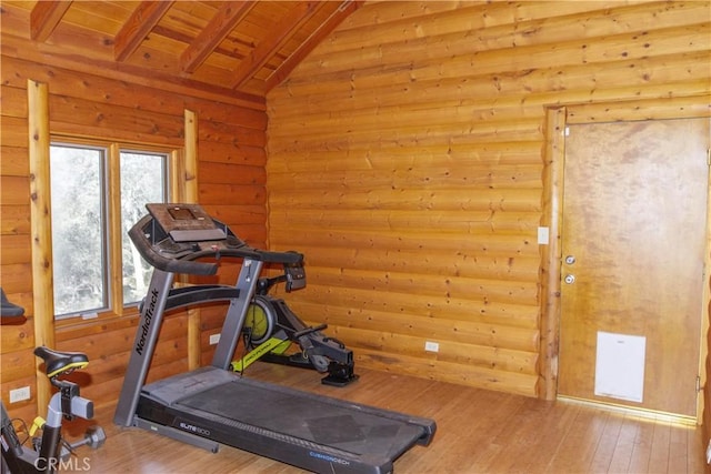 exercise room with wooden ceiling, hardwood / wood-style floors, rustic walls, and lofted ceiling