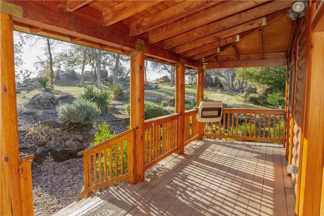 sunroom / solarium featuring lofted ceiling, a healthy amount of sunlight, and heating unit