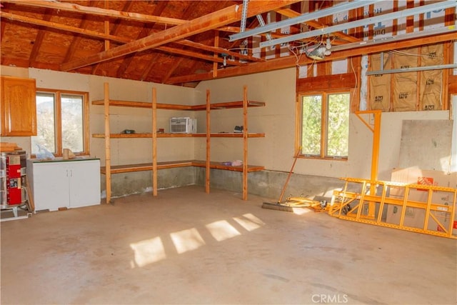 garage with a wall mounted AC and a garage door opener