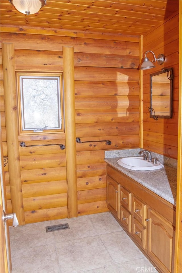 bathroom featuring wooden ceiling, rustic walls, and vanity