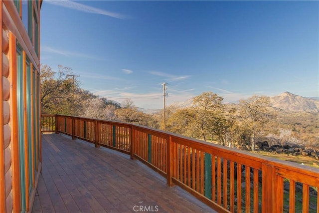 wooden deck with a mountain view