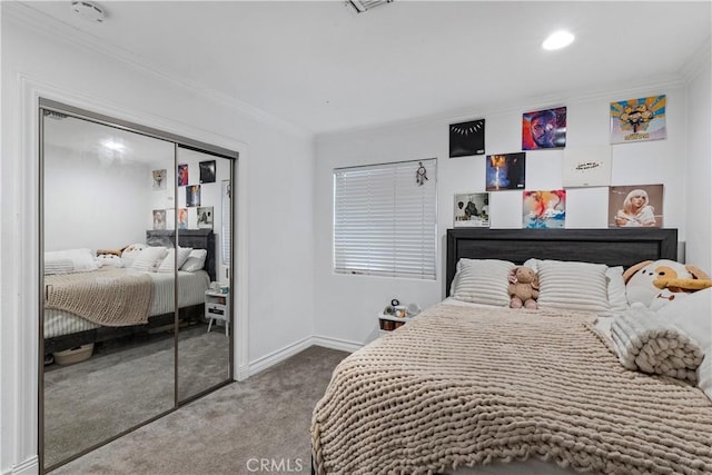 carpeted bedroom with a closet and crown molding