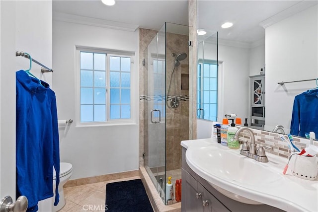 bathroom with ornamental molding, vanity, tile patterned flooring, toilet, and a shower with shower door