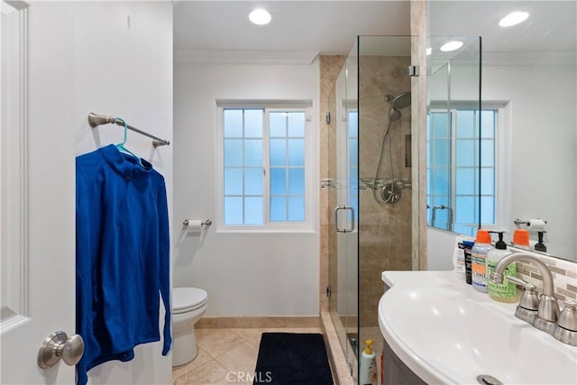 bathroom featuring tile patterned floors, crown molding, sink, and a shower with shower door