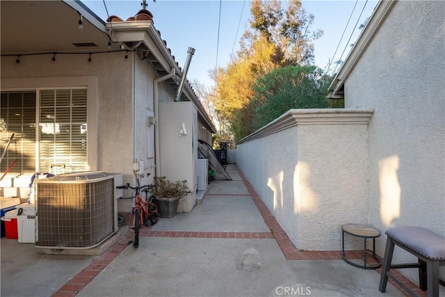 view of home's exterior featuring central AC unit and a patio