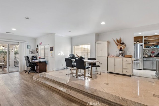 dining space with crown molding