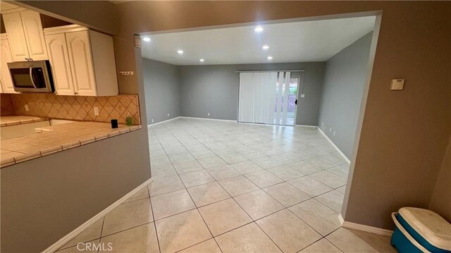 kitchen with light tile patterned floors and decorative backsplash