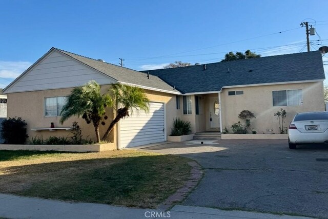 view of front of property with a garage and a front yard