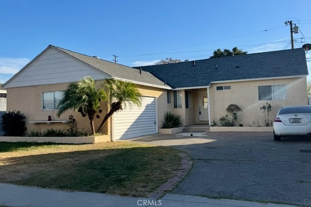 view of front of property featuring a garage and a front lawn