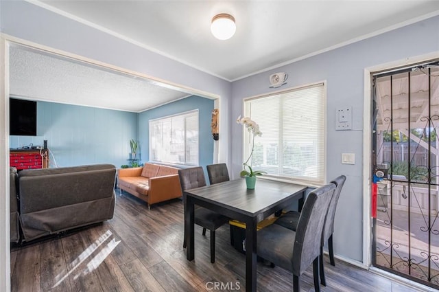 dining space featuring dark hardwood / wood-style flooring and ornamental molding