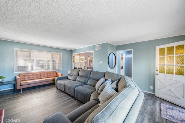 living room featuring hardwood / wood-style flooring and a textured ceiling