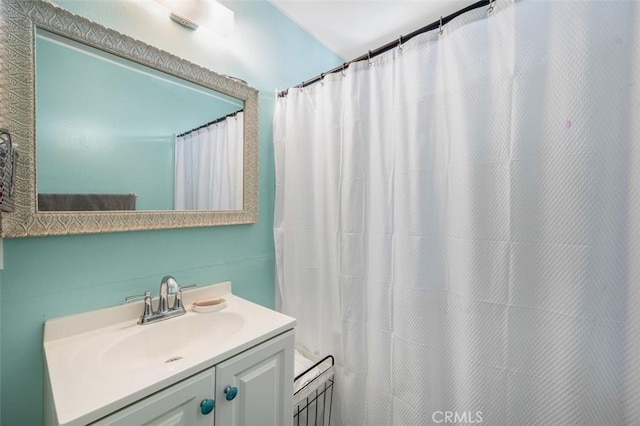 bathroom with vanity and a shower with shower curtain