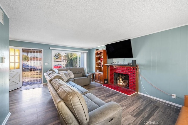 living room featuring a textured ceiling, a fireplace, and dark hardwood / wood-style floors