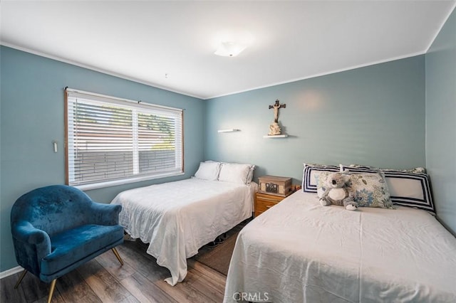 bedroom featuring hardwood / wood-style flooring and crown molding