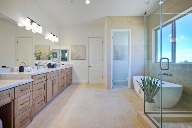 full bathroom with toilet, separate shower and tub, and vanity