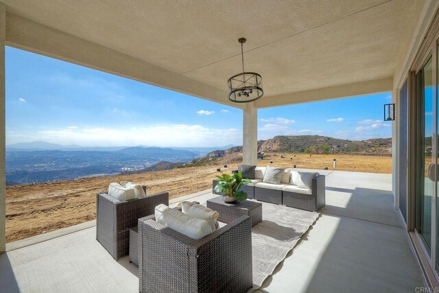 view of patio / terrace featuring a mountain view and an outdoor hangout area