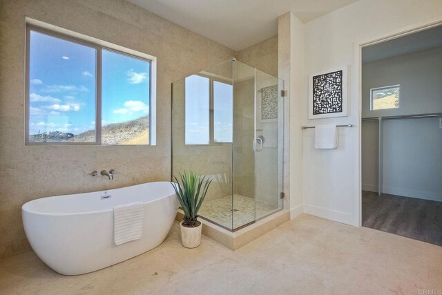 bathroom with shower with separate bathtub