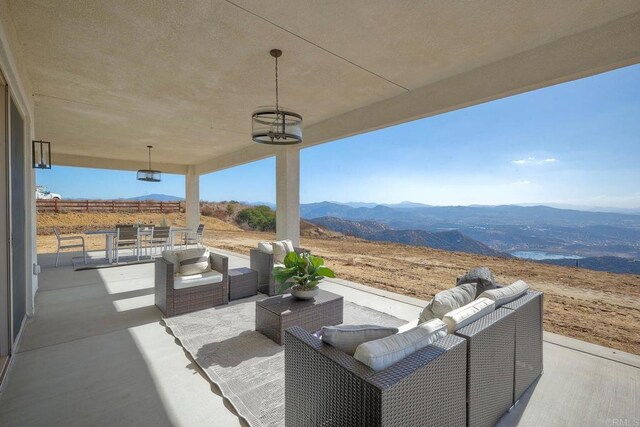 view of patio / terrace with a mountain view and an outdoor hangout area