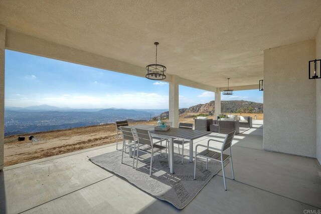 view of patio featuring outdoor lounge area and a mountain view