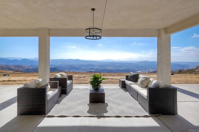 view of patio with a mountain view and outdoor lounge area