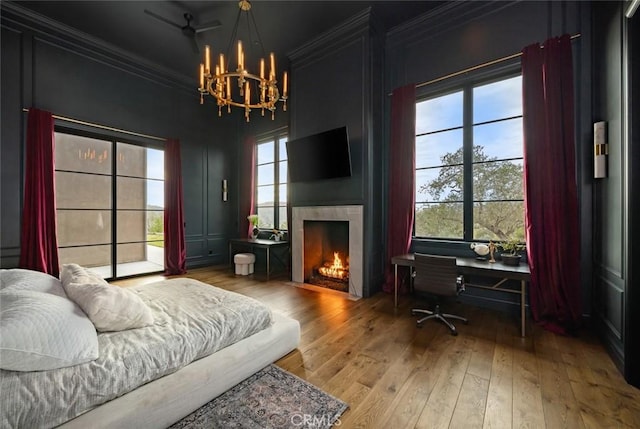 interior space with wood-type flooring, ornamental molding, and a notable chandelier