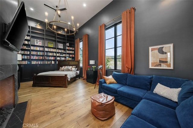 interior space with a high end fireplace, light hardwood / wood-style flooring, and an inviting chandelier