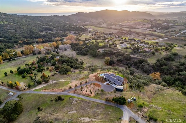 aerial view at dusk featuring a mountain view