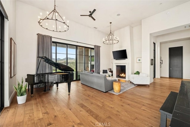 living room with ceiling fan and light hardwood / wood-style flooring