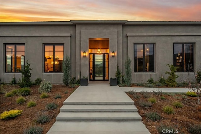 view of exterior entry at dusk