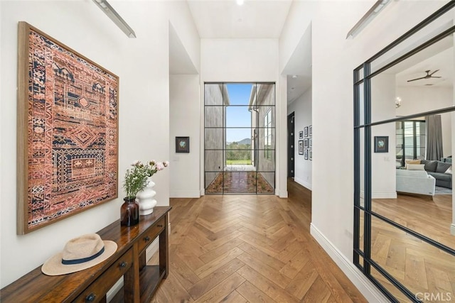 interior space with ceiling fan and parquet flooring