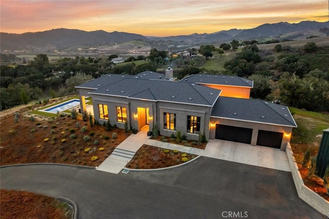 view of front facade featuring a mountain view and a garage