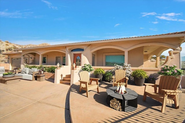 view of patio / terrace featuring an outdoor living space with a fire pit