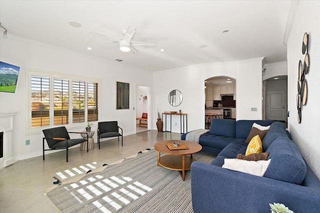 living room with ceiling fan and crown molding