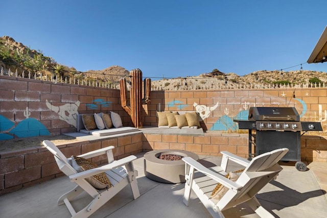 view of patio featuring an outdoor fire pit and grilling area